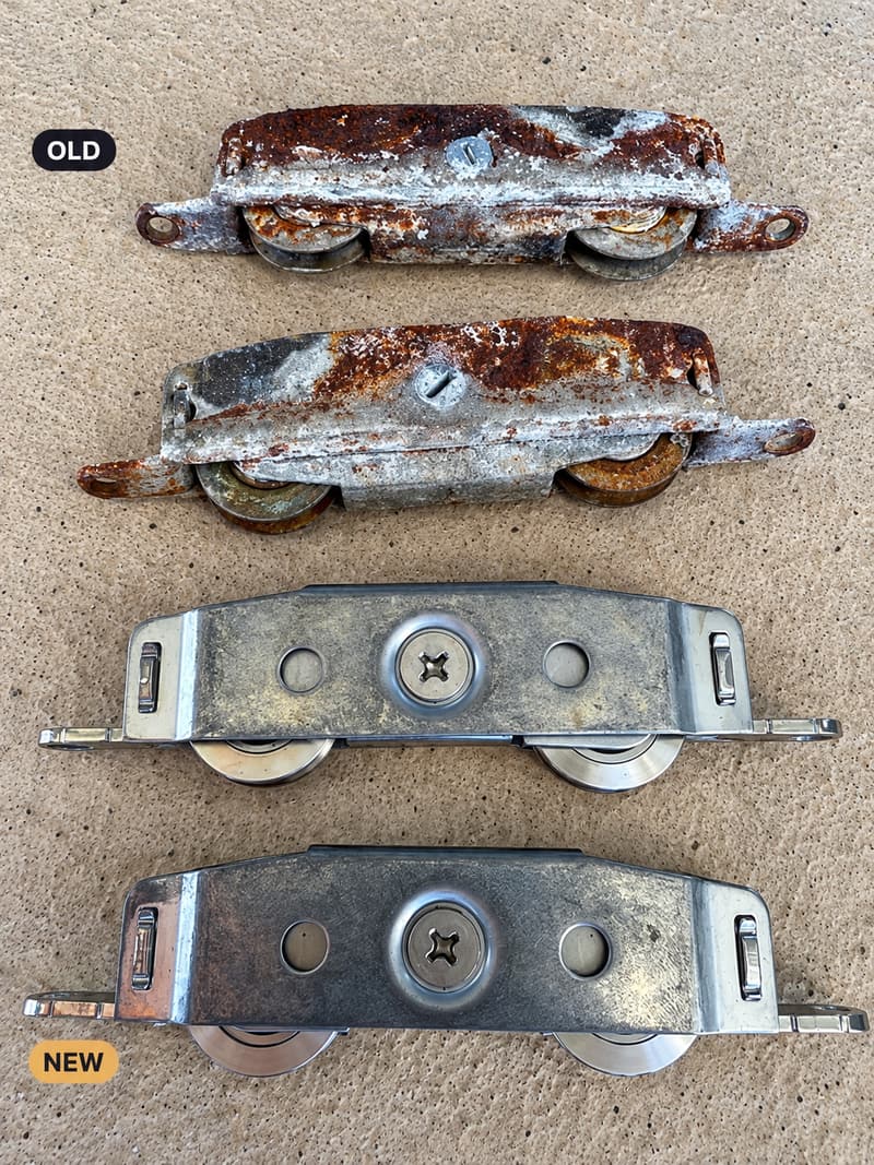 A rusted sliding door roller assembly above a new replacement roller.
